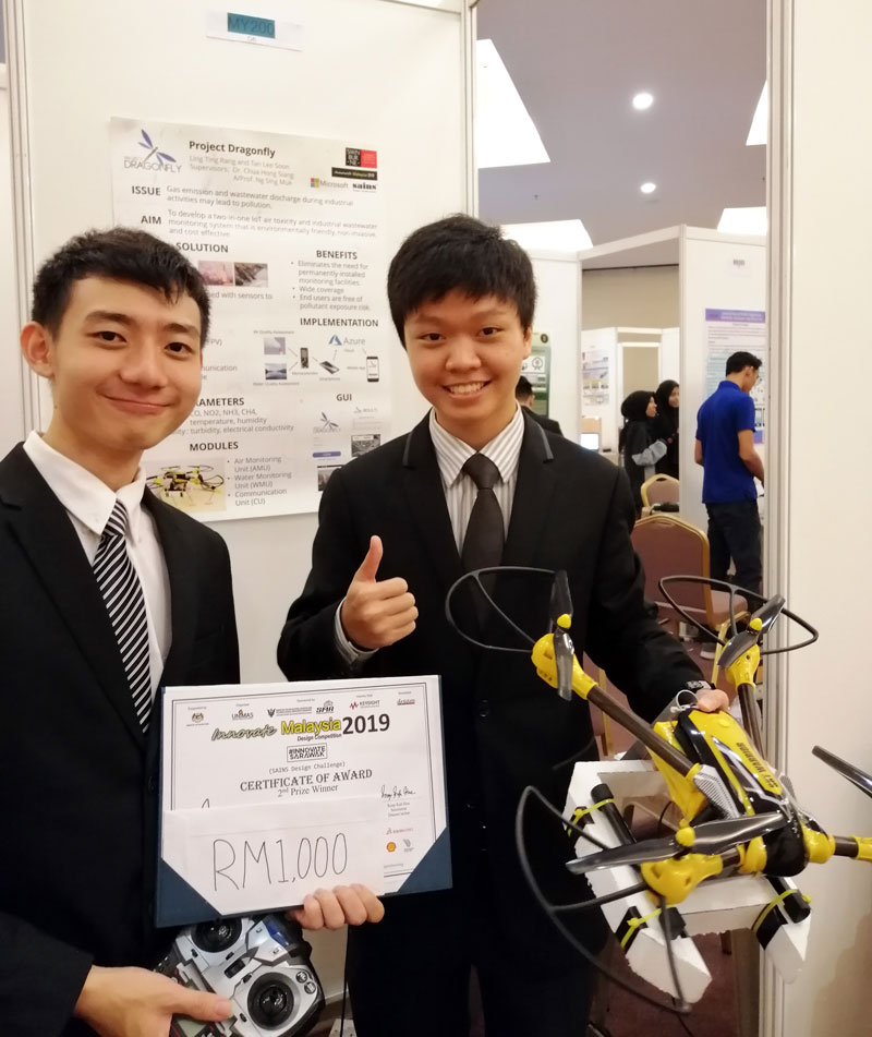 Tan (left) and Ling with their Project Dragonfly prototype that claimed second prize.