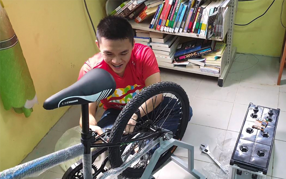 A Swinburne student connects the bicycle to a generator.