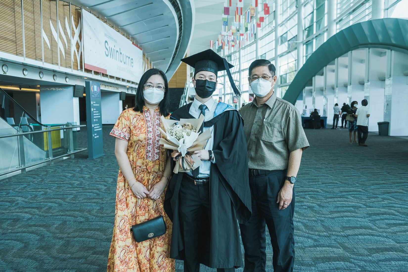 Valedictorian Lai Chung Yi (centre) with his parents.