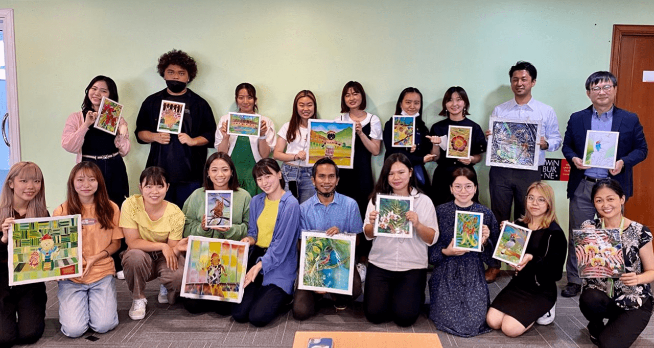 The students show their finished batik paintings which feature themes such as indigenous people as well as flora and fauna of the tropical rainforest. 