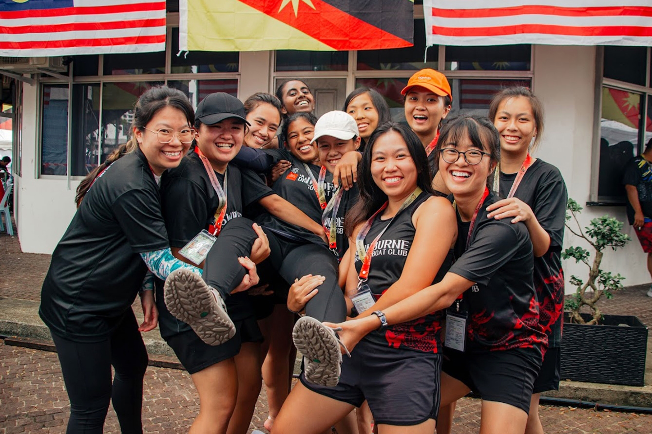 Swinburne Dragons’ International Premier Women 12 crew celebrate qualifying for the semi-finals with their co-captain, Rehvathee a/p Krishnan (being carried).