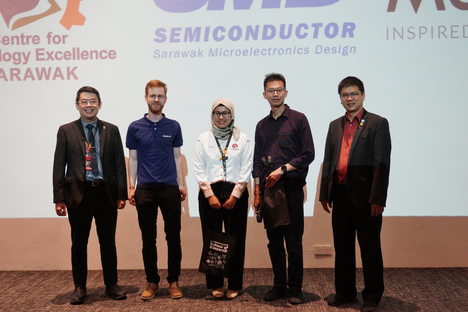 Ir Professor Sim Kwan Yong, Deputy Pro Vice-Chancellor (Academic) (left), presents a token to the plenary session speakers Siti Nor Sabiqah Binti Morshidi (centre), Clement Sim Tih Farn (second right) and Bert Parmentier (second left).