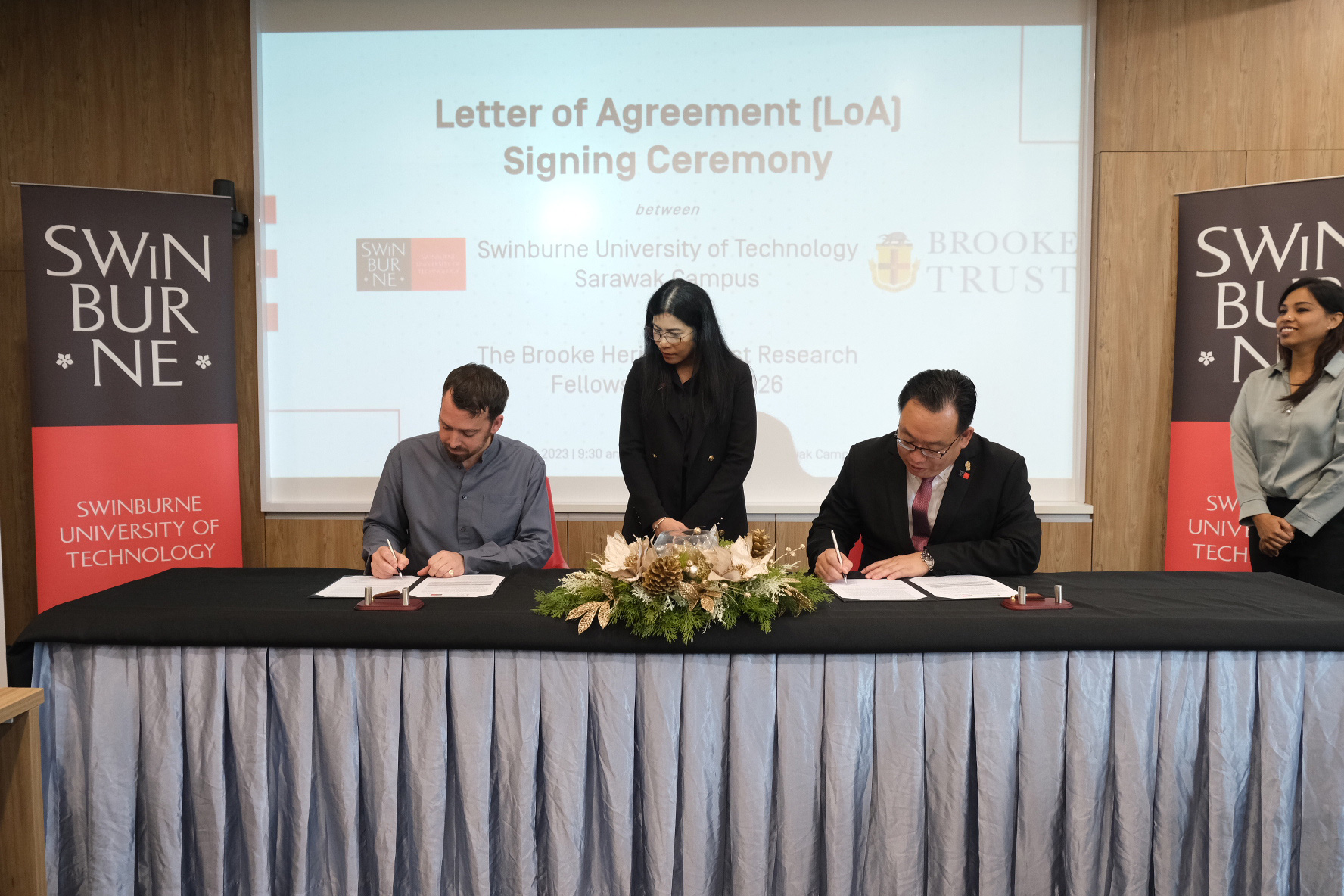 Mr Jason Brooke (seated left) and Ir Professor Lau Hieng Ho (seated right) sign the LoA as Swinburne Sarawak Deputy Pro Vice-Chancellor (Research) Professor Dr Ida Fatimawati bt Adi Badiozaman looks on.