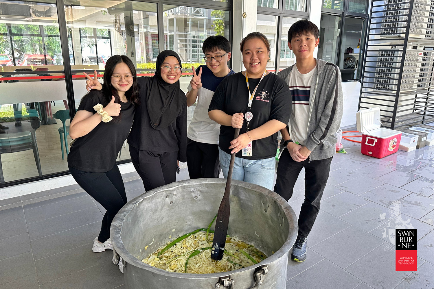 Students participate in the preparation of the bubur lambuk. 