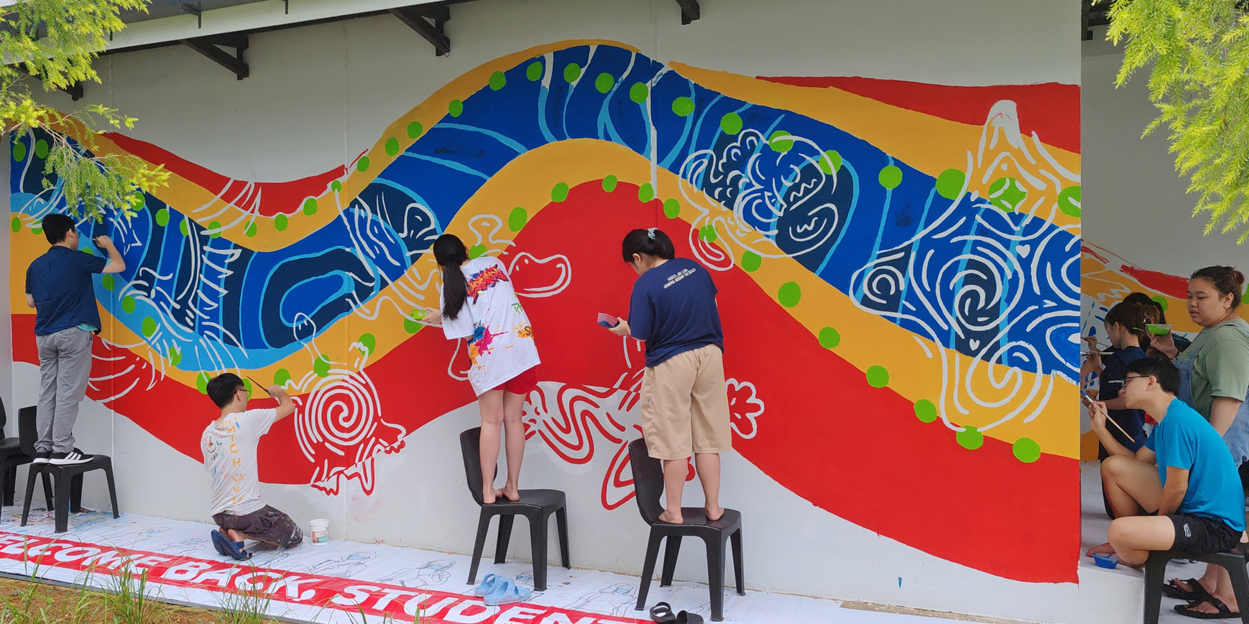 Students work on the mural.