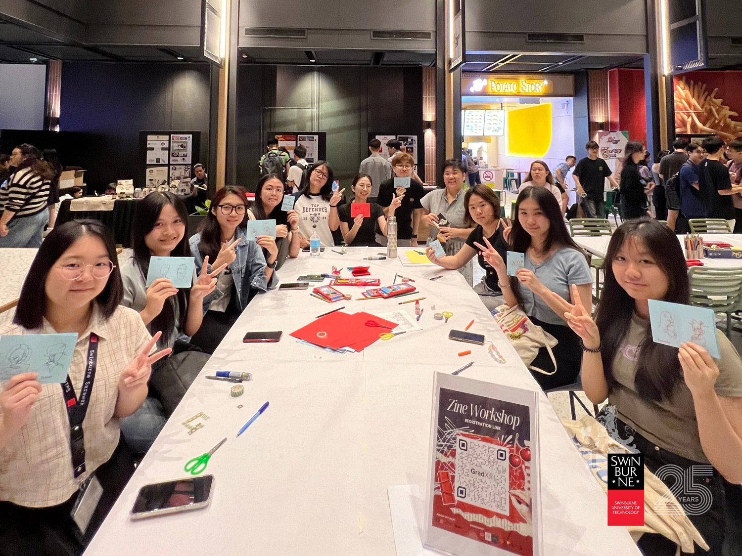 Participants proudly show their creations during the Zine Workshop.