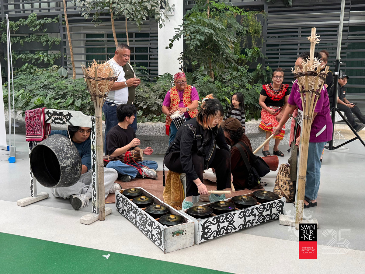 Visitors getting a hands-on experience with traditional music instruments.