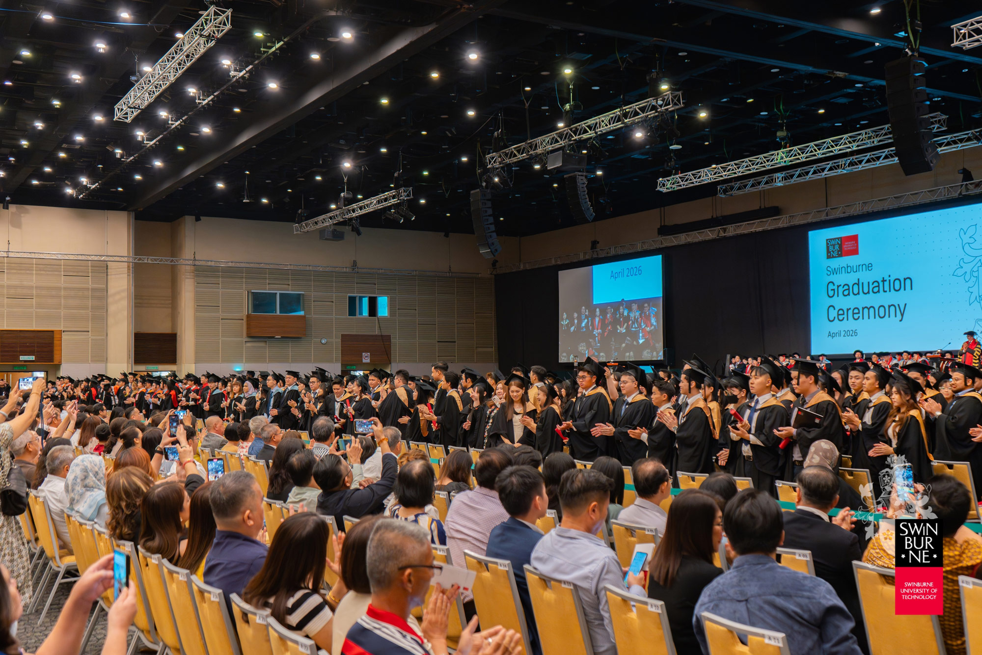 Graduates applaud in appreciation of their families’ support.