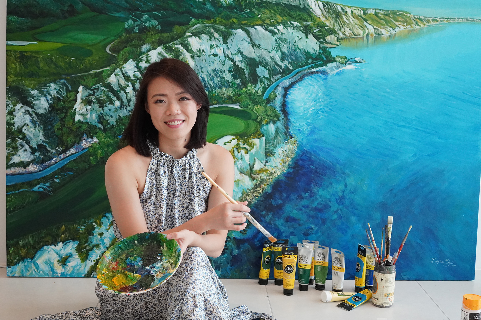 Swinburne Sarawak alumni Daphne Siaw Ai Lin in front of her large-scale painting in Kuching, Sarawak