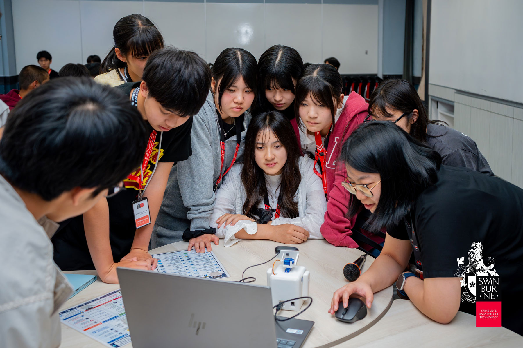 A lecturer guides the students through a hands-on learning session.