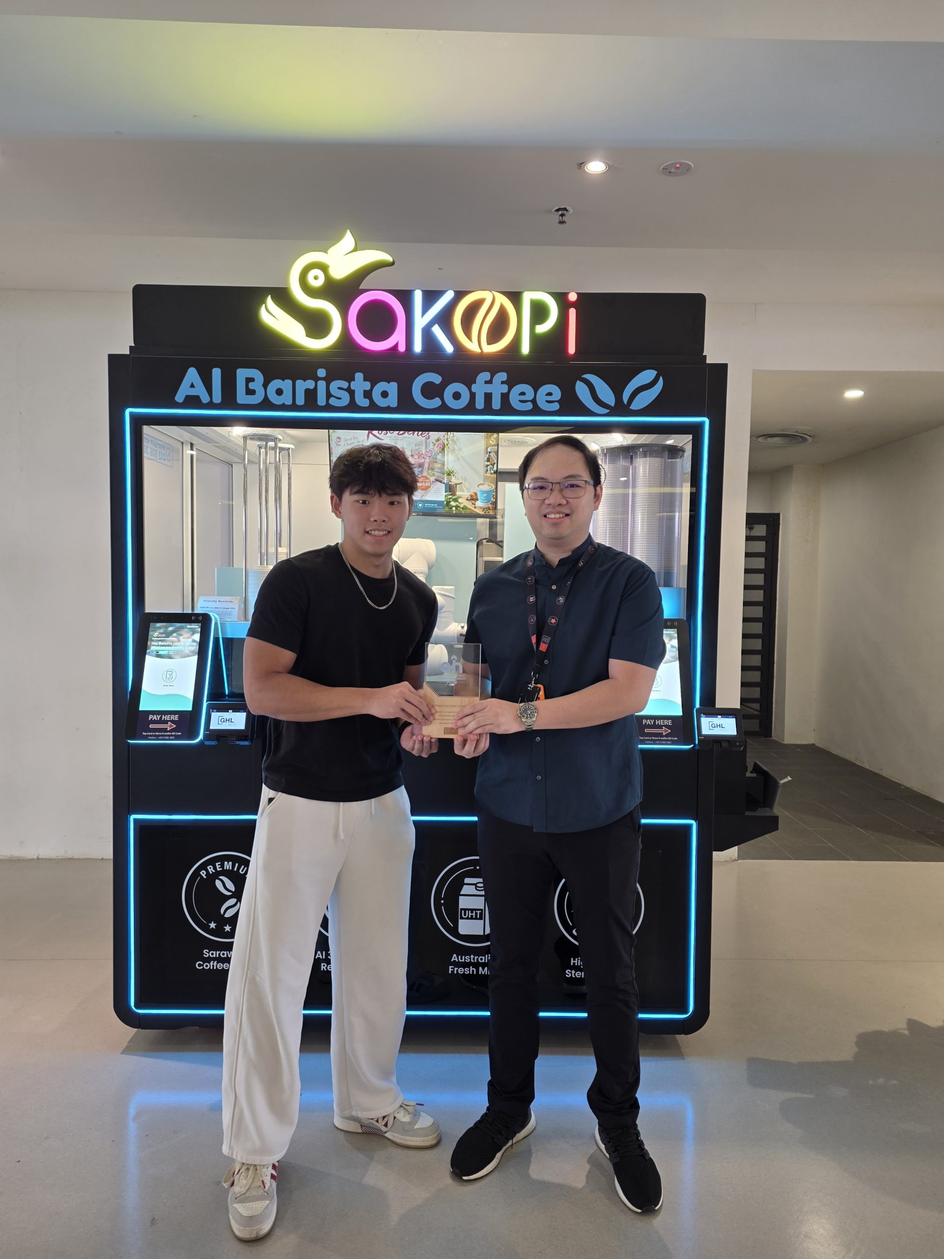 Swinburne Sarawak entrepreneurship students Jesper Aw and Justin Aw at SaKopi, their AI robotic café student venture on the Swinburne Sarawak campus, Kuching Swinburne entrepreneurship studies students, Jesper Aw (left) and Justin Aw, are the faces behind the student-led venture SaKopi.