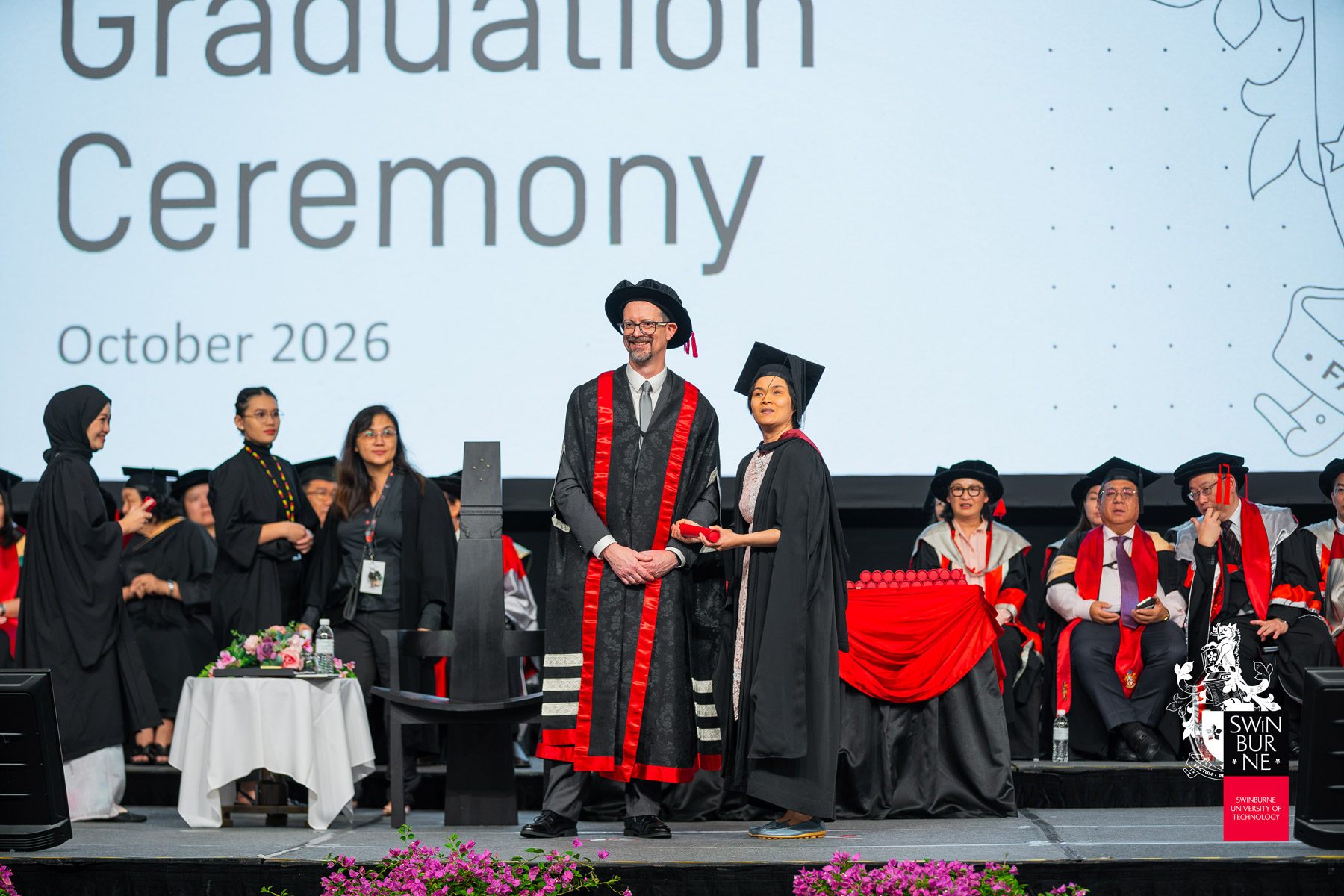 Ruth Yong (centre right) receives her scroll.